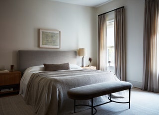 The primary bedroom was moved to the fourth floor and is anchored by a wool and cotton rug from Armadillo. A custom...