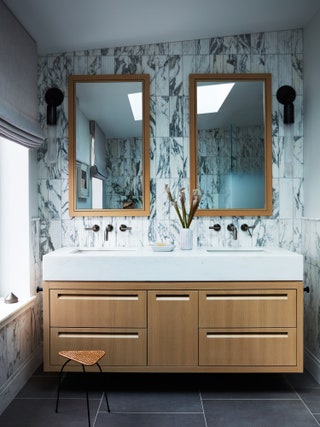 Wallmounted faucets from Phylrich were installed above Kohler undermount sinks in white.