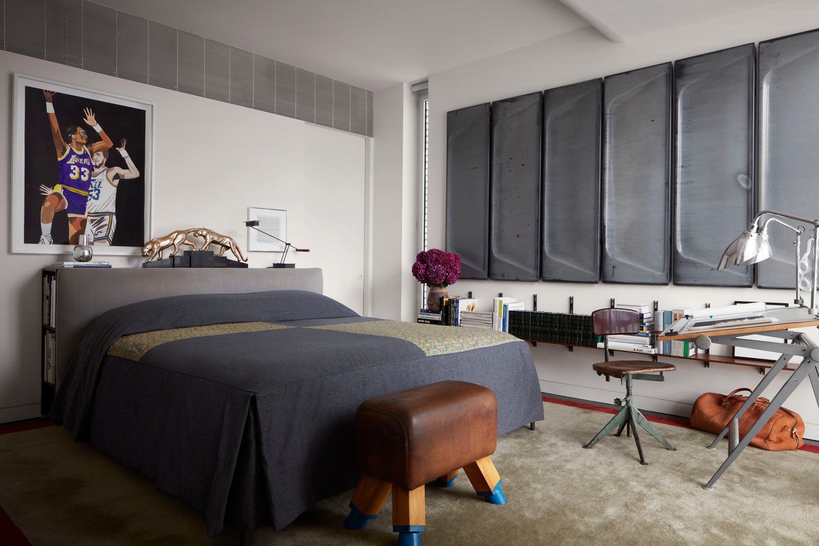 In Andre Mellones Manhattan home the toneddown bed allows the surrounding art and decor to flourish.