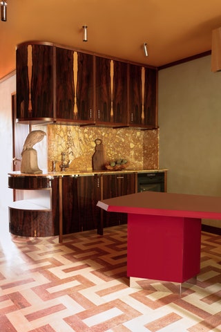 kitchen wood cabinets travertine floors red table