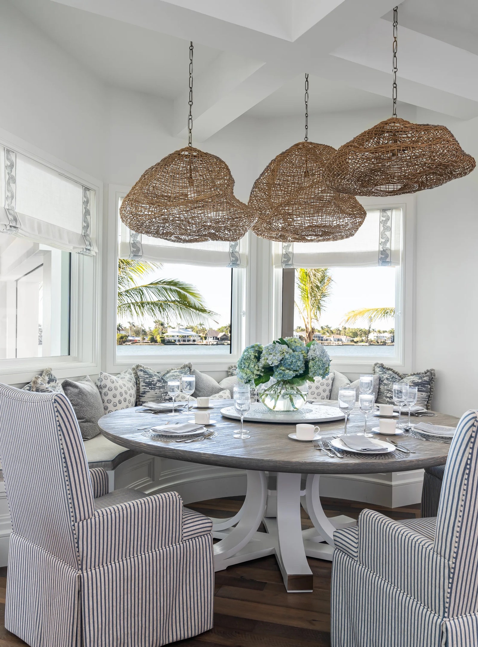 In a Florida project by Design West a customdesigned breakfast nook overlooks the breathtaking Naples Bay.