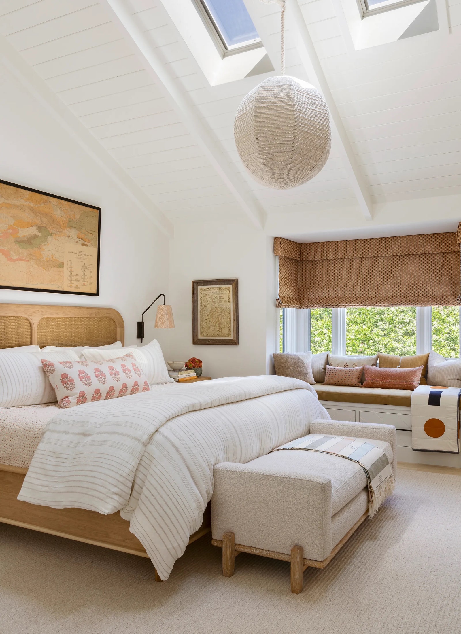 Burnham Design used a neutral palette soft prints textural fabrics and caningquilting details in a primary bedroom...
