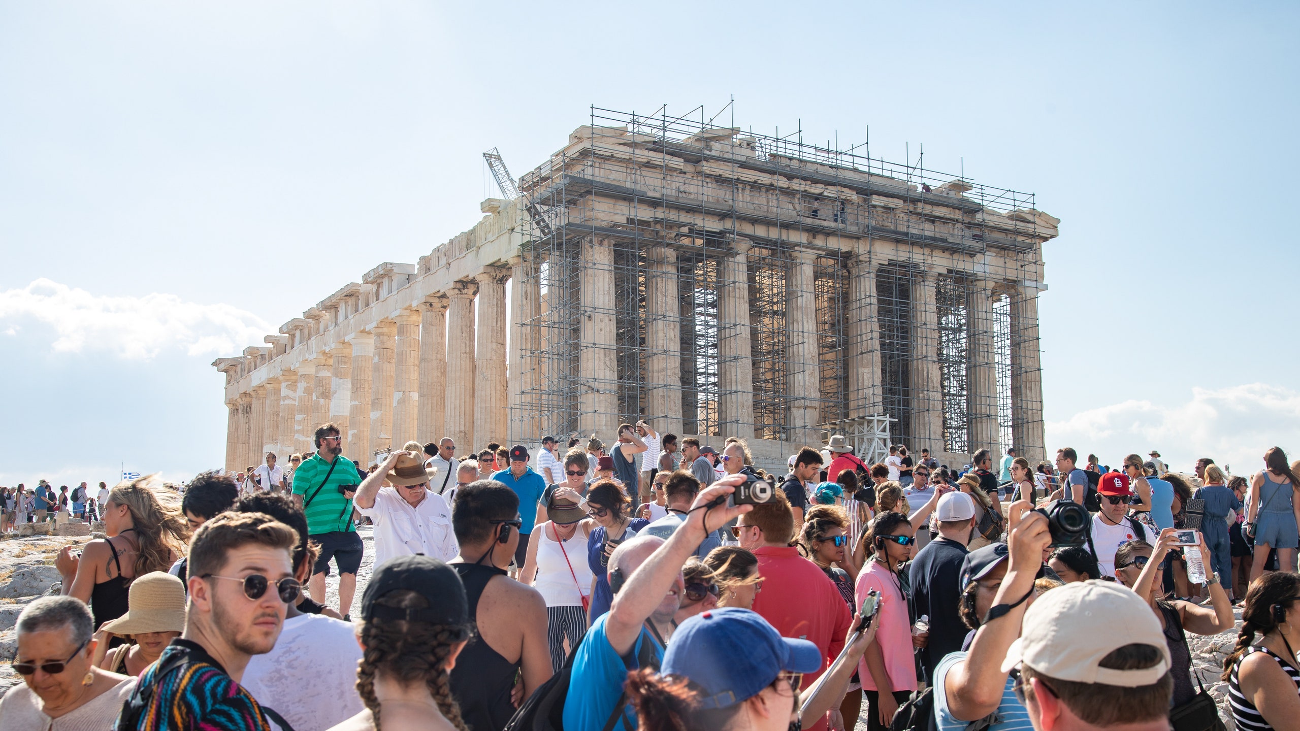 Crowd of tourists surrounding the Acropolis in Athens