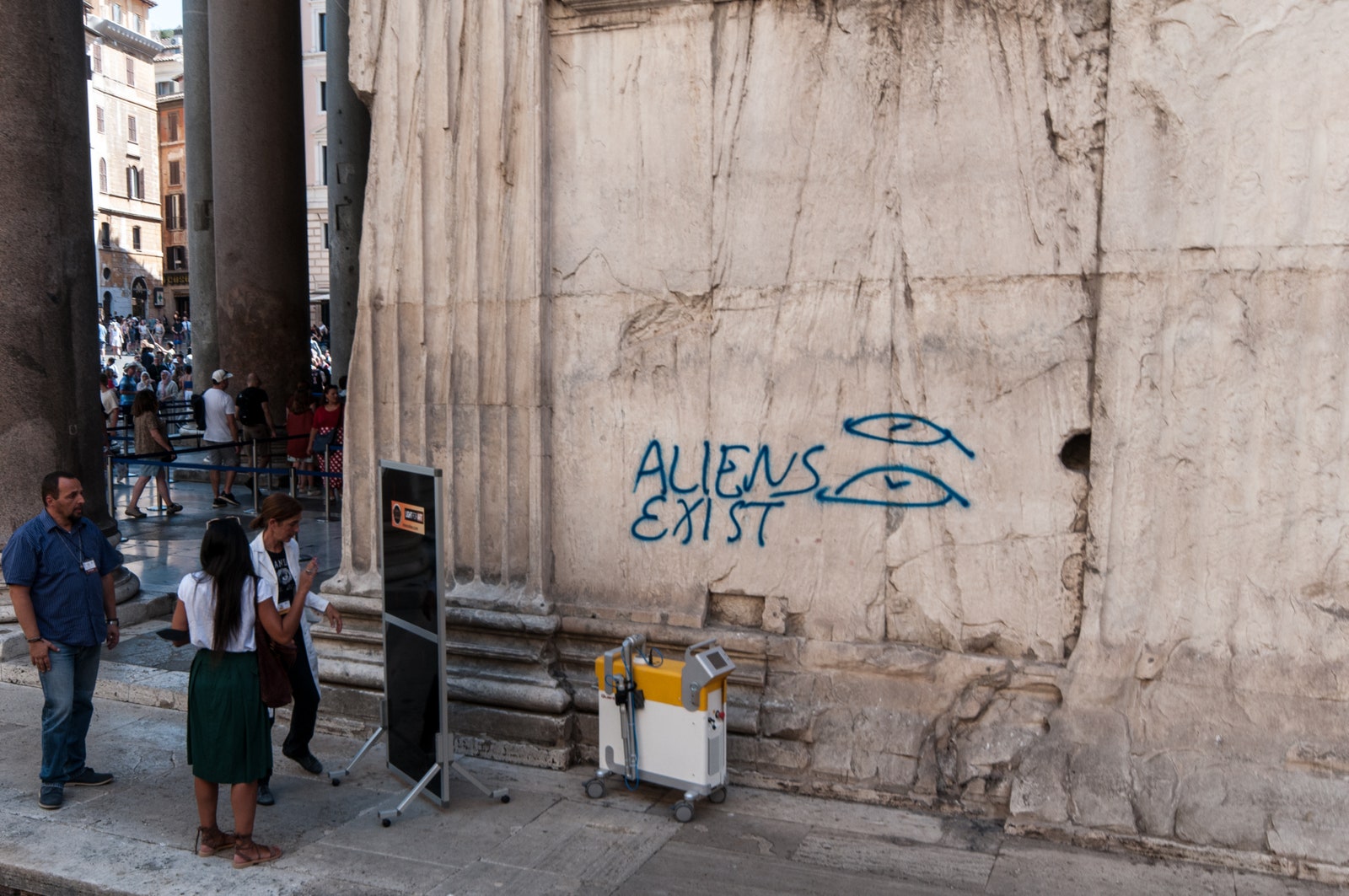 “ALIENS EXIST” blue graffiti on Pantheon wall in Rome Italy