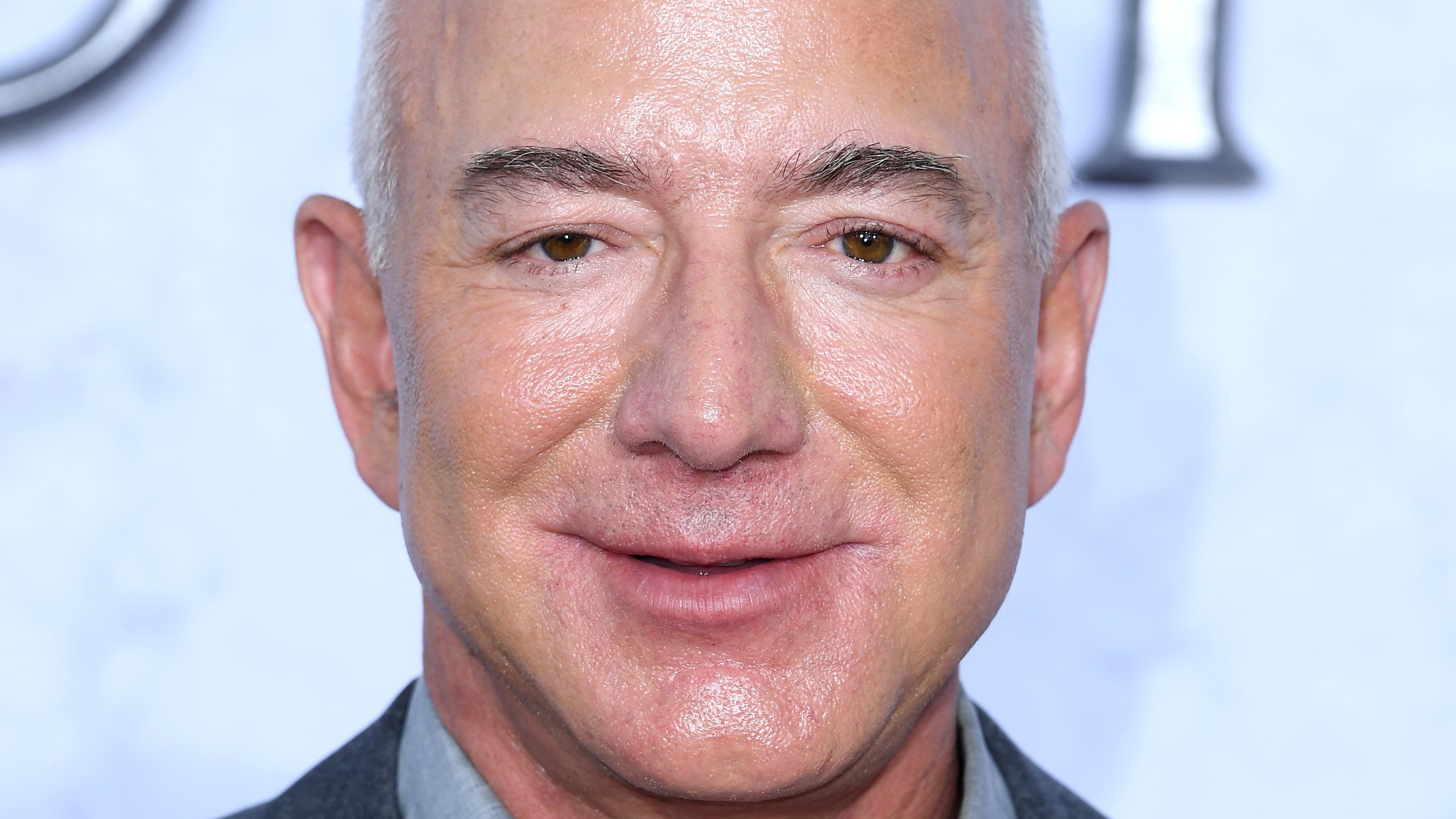 Jeff Bezos in gray suit smiling