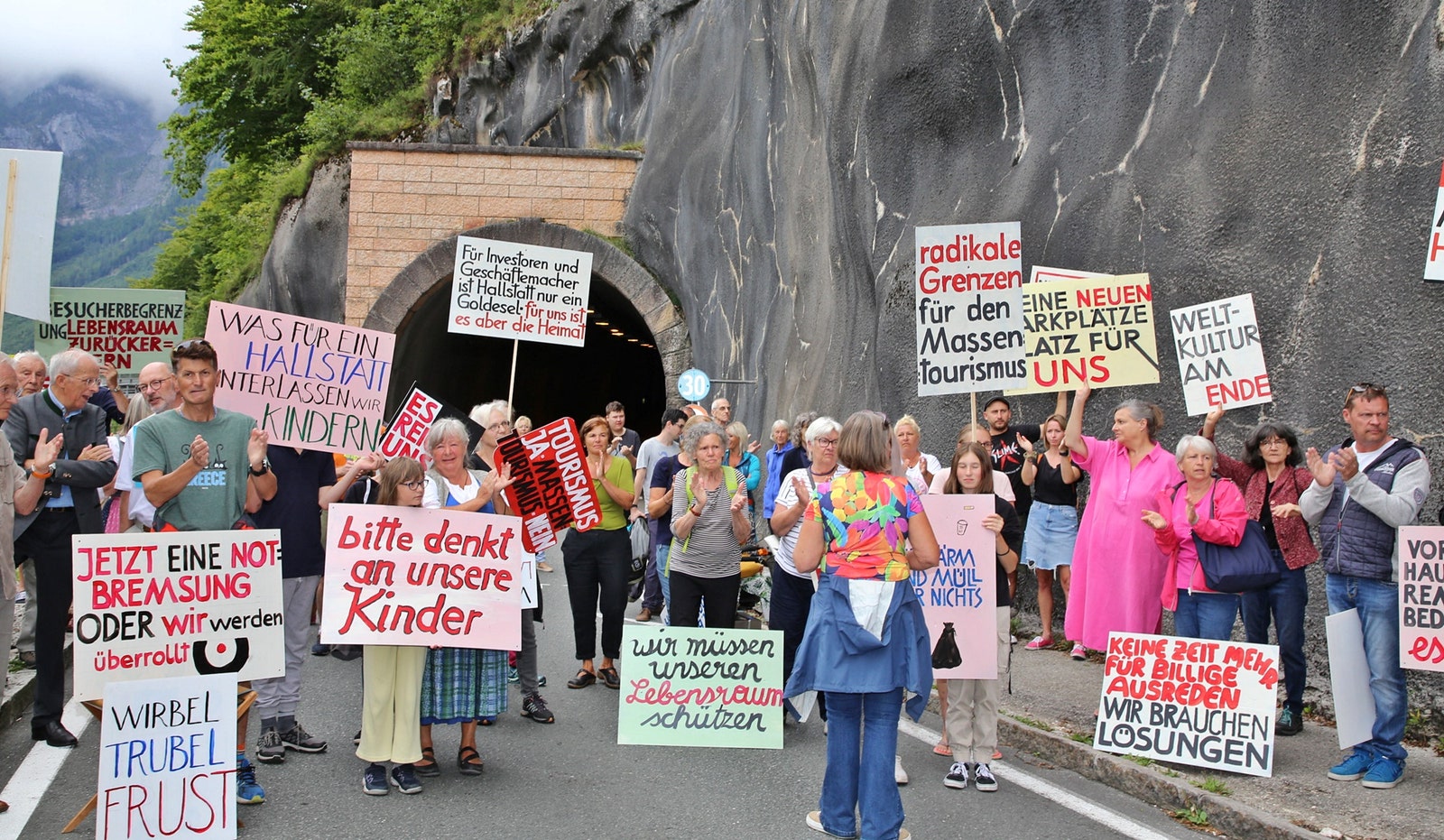 Protesters outside a tunnel on road with signs