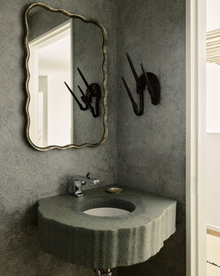 As in the rest of the home the powder room is a play on tactility with a custom sink made of bluestone T.D. Sidell...