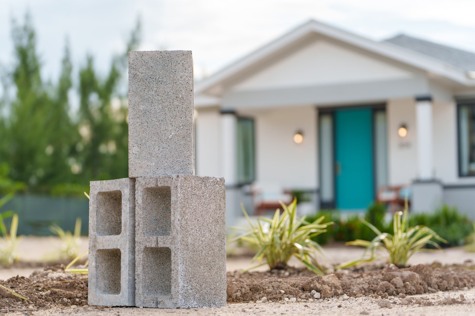 concrete blocks with a home in the foreground