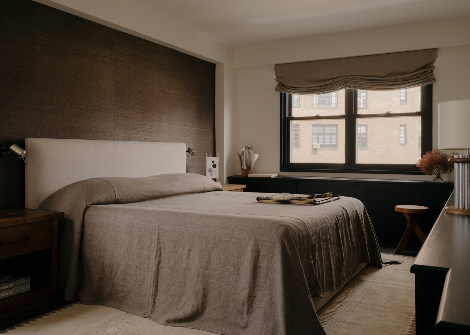 A muddy graytoned bedcover softens a monochrome bedroom in West Village home transformed by designer Sebastian Zuchowicki.